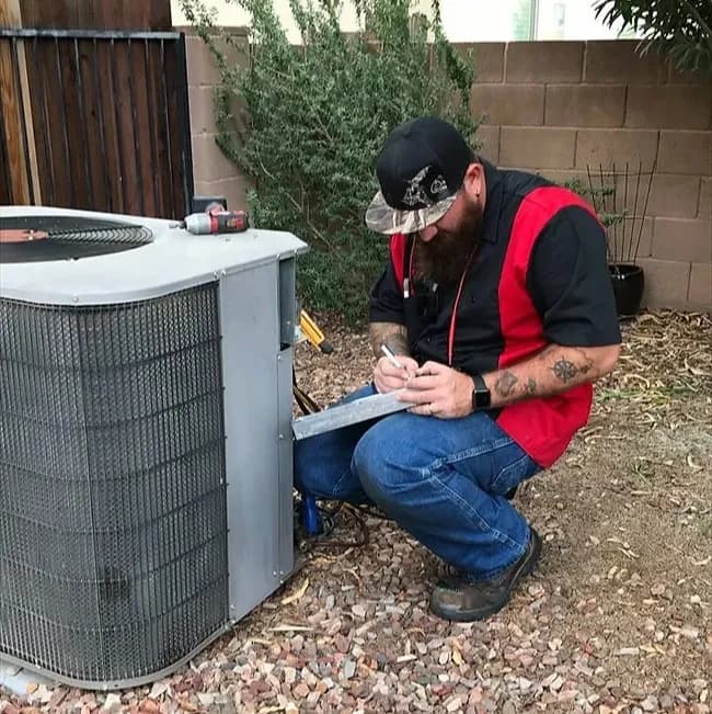 Technician installing AC equipment