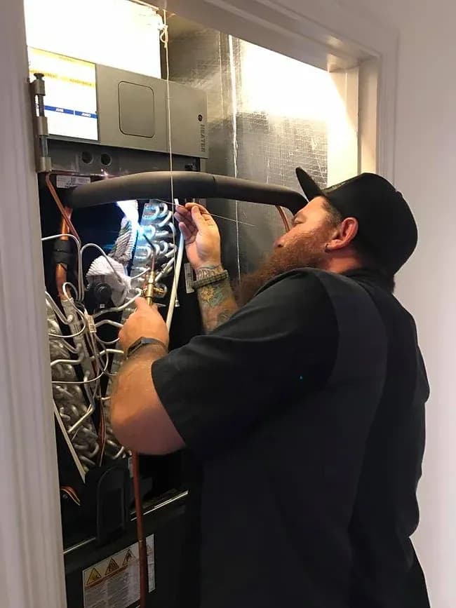 AC technician repairing an HVAC system