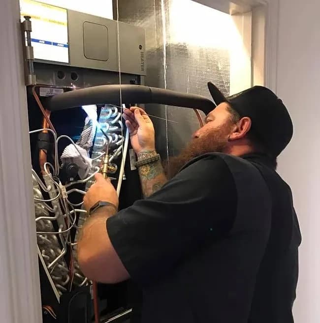 Technician performing AC maintenance